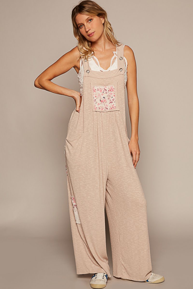 Ribbed Jumpsuit With Adjustable Button Strap, Center Front Pocket With Printed Patch Detailing, Side Pockets, And Side Lace Patches