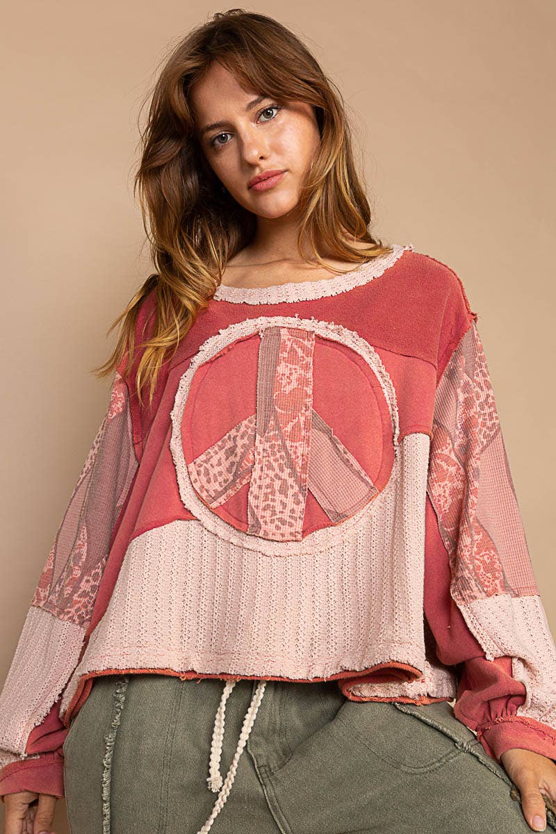 Round neck long sleeve cut sew peace emblem knit top